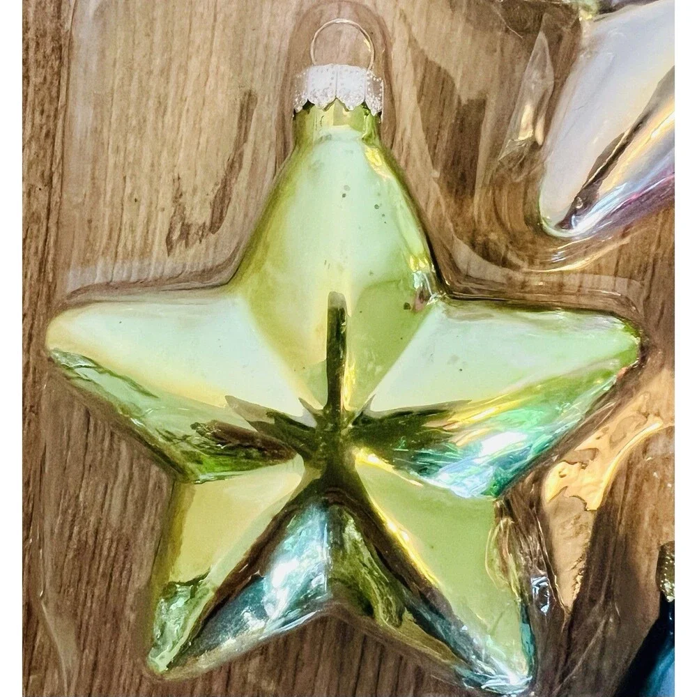 Handcrafted Glass Ornament Set features four star-shaped ornaments metallic